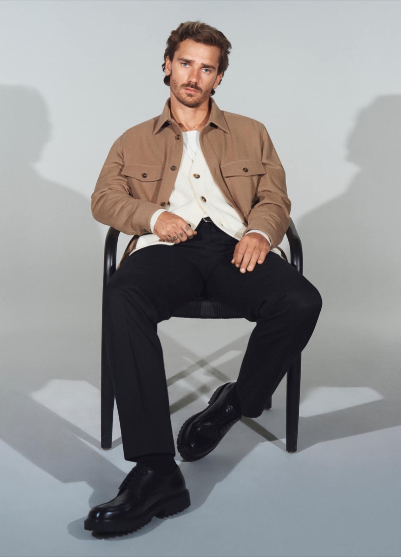 Fronting the Mango “Move Forward” campaign, Antoine Griezmann sports a wool overshirt with a cardigan sweater.