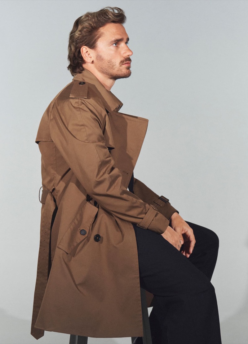 Reuniting with Mango for fall 2024, Antoine Griezmann wears a brown trench.