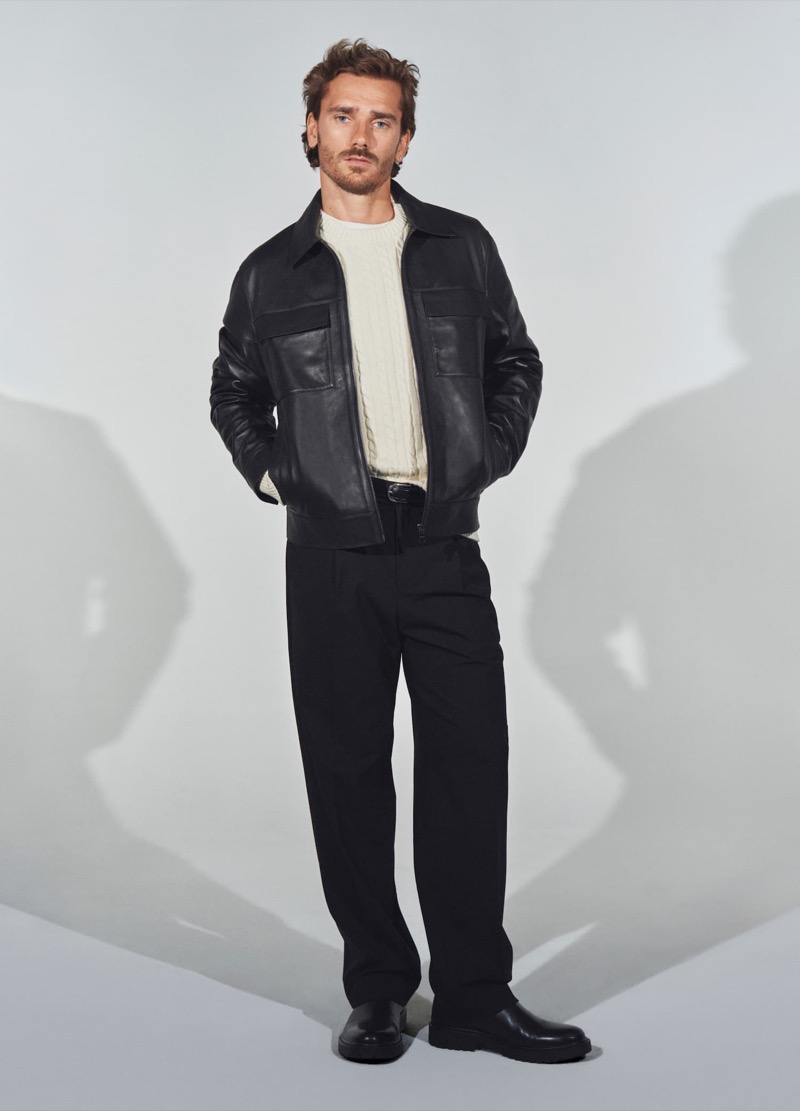 Antoine Griezmann sports a leather jacket, cable-knit sweater, and straight-fit pants by Mango.