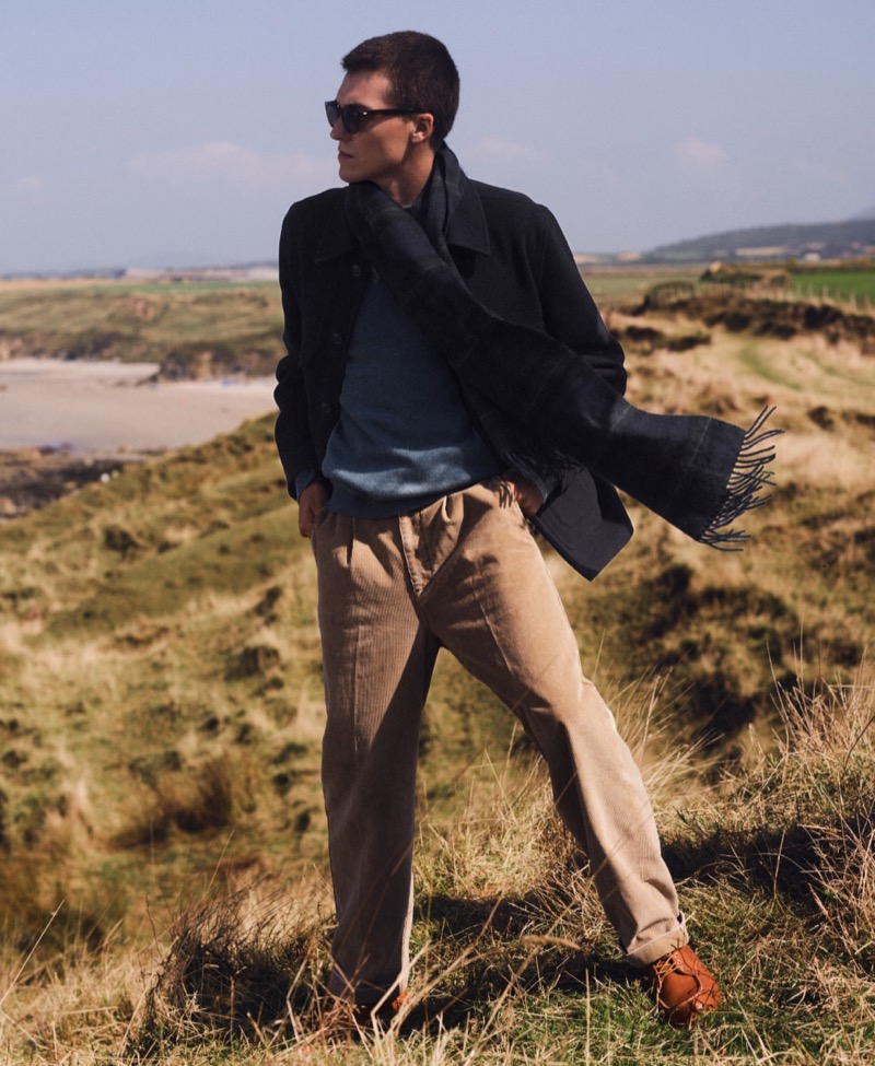 Casper Williams models a cashmere scarf, relaxed-fit pleated 11-wale corduroy trousers, and a University coat by J.Crew. 