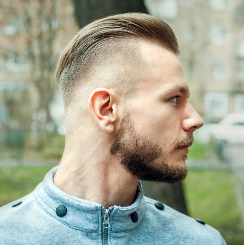 A razor fade transforms the slick back into a sleek, structured hairstyle. 