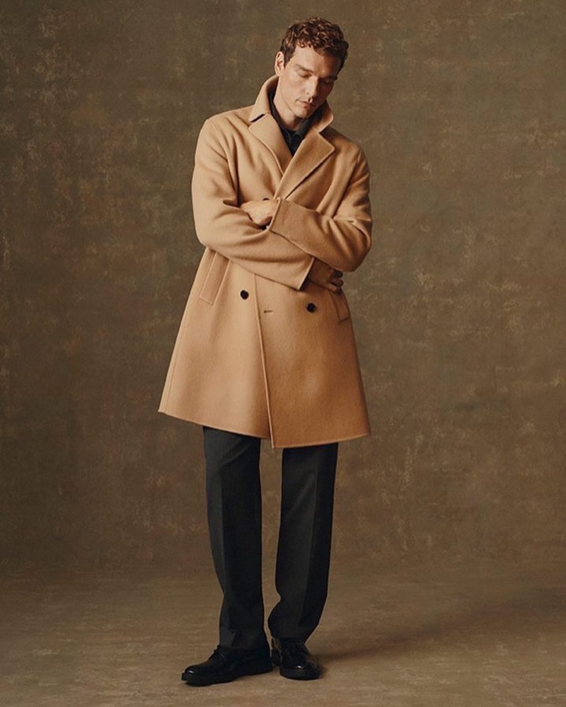 Model Alexandre Cunha wears Theory’s double-breasted coat in camel.